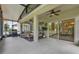 Spacious screened patio with a comfortable seating area, ceiling fans, and outdoor grill at 17676 Passionflower Cir, Clermont, FL 34714