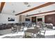 Outdoor patio with seating, tables, ceiling fans, a bar, and outdoor televisions at 17676 Passionflower Cir, Clermont, FL 34714