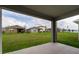 The covered patio has a view of the large, well-maintained backyard at 1792 Bull Hill Rd, Kissimmee, FL 34744