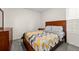 Bedroom with patterned bedding, a dresser, a nightstand, and a window with natural light at 1792 Bull Hill Rd, Kissimmee, FL 34744
