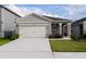 Charming single-story home featuring a neutral color palette and a spacious two-car garage at 1792 Bull Hill Rd, Kissimmee, FL 34744