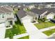 Aerial front exterior of home with a well-manicured lawn, long driveway, and tidy landscaping at 1792 Bull Hill Rd, Kissimmee, FL 34744