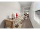 Inviting hallway featuring tile floors, neutral walls and stylish console table decorations at 1792 Bull Hill Rd, Kissimmee, FL 34744