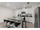 Modern kitchen features an island with seating, granite countertops and stainless steel appliances at 1792 Bull Hill Rd, Kissimmee, FL 34744