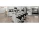 Open kitchen featuring an island with granite countertops, seating and stainless steel appliances at 1792 Bull Hill Rd, Kissimmee, FL 34744