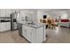 Open concept kitchen with an island and stainless steel appliances overlooking the dining area at 1792 Bull Hill Rd, Kissimmee, FL 34744