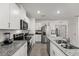 Modern kitchen features white cabinets, stainless appliances, granite countertops, and a functional island at 1792 Bull Hill Rd, Kissimmee, FL 34744
