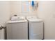 Convenient laundry room featuring a modern white washer and dryer at 1792 Bull Hill Rd, Kissimmee, FL 34744