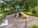 Community playground with a slide, climbing wall, benches, and a covered area at 1792 Bull Hill Rd, Kissimmee, FL 34744