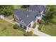 Aerial shot of a house with a dark roof, a turret, and lush lawns surrounded by mature trees at 2101 Lily Ct, Sanford, FL 32771