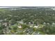 Panoramic aerial view of a lush neighborhood with mature trees and glimpses of a distant lake at 2101 Lily Ct, Sanford, FL 32771