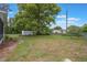 Spacious backyard featuring a large shade tree, storage shed, and full fencing for privacy at 2101 Lily Ct, Sanford, FL 32771