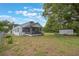 View of the backyard featuring a screened-in porch and a storage shed for added convenience at 2101 Lily Ct, Sanford, FL 32771