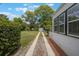 Spacious backyard featuring a lush lawn, a storage shed, and a concrete pathway to the side of the home at 2101 Lily Ct, Sanford, FL 32771