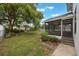 A spacious, grassy backyard with a shed, screened porch, and mature trees at 2101 Lily Ct, Sanford, FL 32771