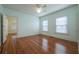 This bright bedroom features wood floors, two windows, and a ceiling fan at 2101 Lily Ct, Sanford, FL 32771