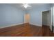 Spacious bedroom features wood floors, an open closet, and a ceiling fan at 2101 Lily Ct, Sanford, FL 32771
