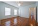Bright bedroom features wood floors, ceiling fan, and abundant natural light from large windows at 2101 Lily Ct, Sanford, FL 32771