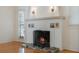 Close up of the living room fireplace with decorative brick surround and tiled hearth at 2101 Lily Ct, Sanford, FL 32771