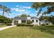 Charming home with a red door, green lawn, and well-maintained landscaping at 2101 Lily Ct, Sanford, FL 32771