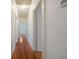 Bright hallway featuring wood flooring, access to other rooms, and neutral paint at 2101 Lily Ct, Sanford, FL 32771