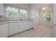 Bright kitchen featuring white cabinets, a dishwasher, and open access to the dining area at 2101 Lily Ct, Sanford, FL 32771