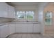 Bright kitchen featuring white cabinets, a dishwasher, and lots of natural light at 2101 Lily Ct, Sanford, FL 32771