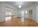 Bright living room with a chandelier, open layout, hardwood flooring, and white walls at 2101 Lily Ct, Sanford, FL 32771