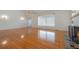 Bright, open living room with gleaming hardwood floors and fireplace at 2101 Lily Ct, Sanford, FL 32771