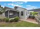 The rear exterior features a screened porch and a well-maintained lawn at 2101 Lily Ct, Sanford, FL 32771