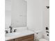 White bathroom features a single sink, a large mirror, and a bathtub with shower at 2296 Brix Sts, Orlando, FL 32804