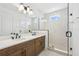 This bathroom features double sinks, modern fixtures, and a walk-in shower with herringbone tile at 2296 Brix Sts, Orlando, FL 32804