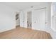 Bedroom featuring wood-look floors with an attached closet and bathroom at 2296 Brix Sts, Orlando, FL 32804