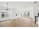 Open-concept living room featuring wood-look floors and multiple windows for ample natural light at 2296 Brix Sts, Orlando, FL 32804