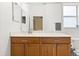 Bathroom featuring wooden vanity with granite countertop and large mirror, and tile floors at 2422 Holly Pine Cir, Orlando, FL 32820