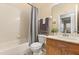 Bathroom with standard toilet, shower-tub combo with shower curtain, and wooden vanity with a mirror at 2422 Holly Pine Cir, Orlando, FL 32820