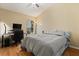 Bedroom featuring laminated floors, standard closet, ceiling fan, desk/office, and window at 2422 Holly Pine Cir, Orlando, FL 32820