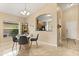 Modern dining area with a round glass table, stylish chairs, and an open view into the adjacent kitchen at 2422 Holly Pine Cir, Orlando, FL 32820