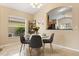 Cozy dining area with modern decor, neutral walls, and a clear view into the bright and functional kitchen at 2422 Holly Pine Cir, Orlando, FL 32820