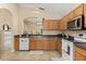 Practical kitchen features wood cabinets, tile flooring, and a streamlined design for efficient meal preparation and cleanup at 2422 Holly Pine Cir, Orlando, FL 32820