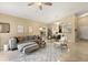 Bright living room with a stylish gray sofa, patterned rug, and adjacent dining area for comfortable living at 2422 Holly Pine Cir, Orlando, FL 32820