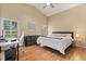 Spacious main bedroom with vaulted ceilings, wood floors, bright windows, and a king bed with home office area at 2422 Holly Pine Cir, Orlando, FL 32820