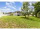Expansive backyard featuring a well-maintained lawn and mature trees, enclosed by a white fence at 2588 Gabrielle Woods Pl, Oviedo, FL 32765