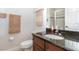 Well-lit bathroom featuring granite countertops, wooden cabinets, and a glass-enclosed shower at 2588 Gabrielle Woods Pl, Oviedo, FL 32765