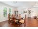 Traditional dining room with wood floors, chandelier, and windows with shutter-style blinds at 2588 Gabrielle Woods Pl, Oviedo, FL 32765