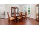 Elegant dining room with a large china cabinet, beautiful hardwood floors, and dining table set for six at 2588 Gabrielle Woods Pl, Oviedo, FL 32765