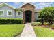 Inviting front entrance with a stone archway and professionally landscaped garden at 2588 Gabrielle Woods Pl, Oviedo, FL 32765