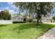 A beautifully landscaped front yard featuring a large tree and neatly trimmed hedges at 2588 Gabrielle Woods Pl, Oviedo, FL 32765