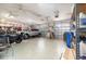 Spacious garage with car, motorcycle, storage racks, epoxy flooring and multiple ceiling fans at 2588 Gabrielle Woods Pl, Oviedo, FL 32765