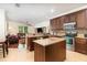 Open concept kitchen with an island and granite countertops that flows to the living room at 2588 Gabrielle Woods Pl, Oviedo, FL 32765